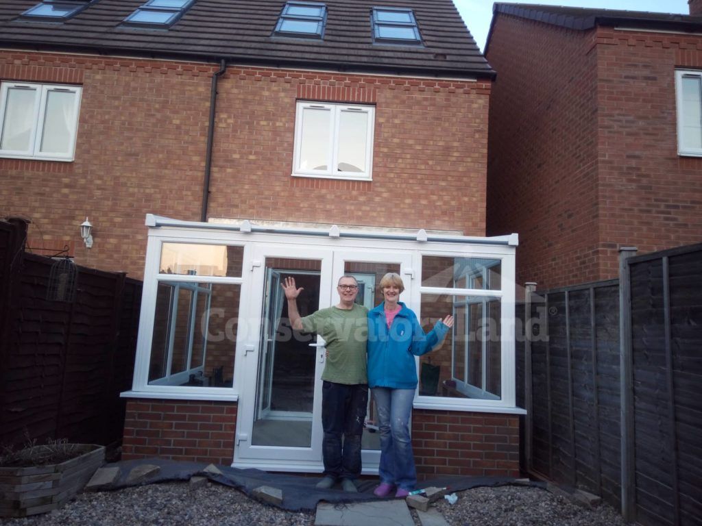 Mr and Mrs Baker standing outside their new DIY Conservatory