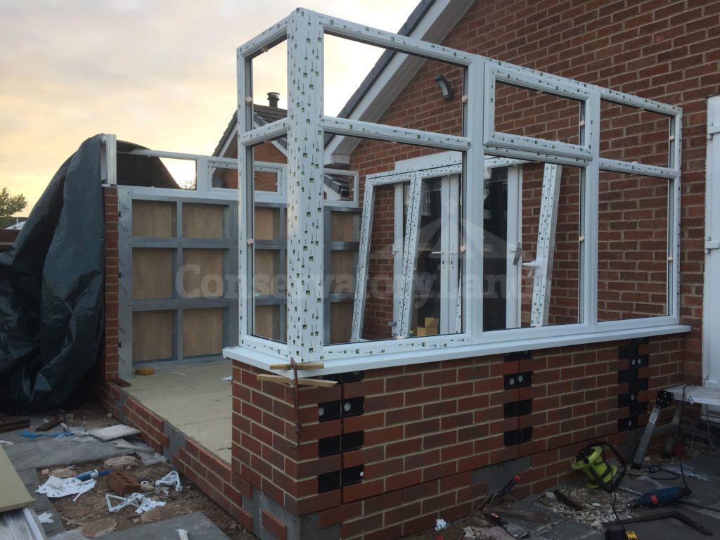 white conservatory frame being erected