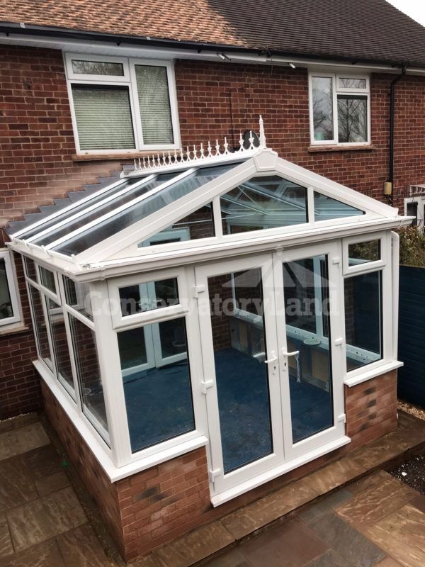 Gable front conservatory with solar glass and a high vaulted roof to amplify light and space