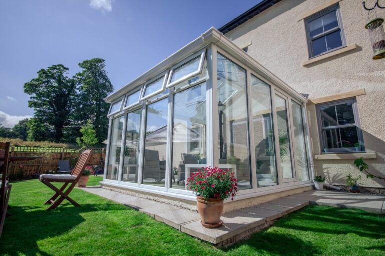 a conservatory with full height glass windows