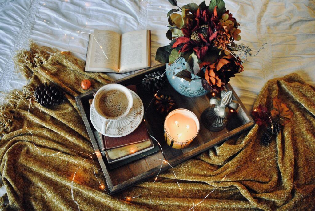 Cosy autumnal flat lay with coffee and candle