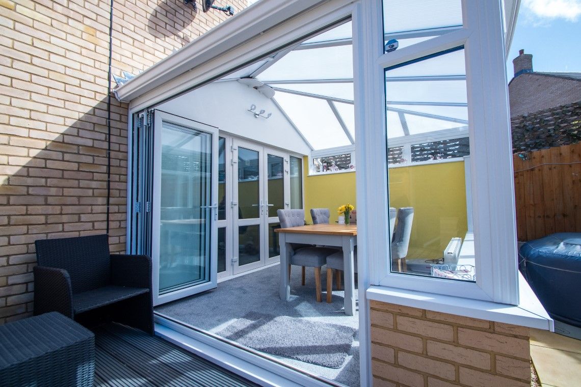 hipped lean-to conservatory with bi-fold doors